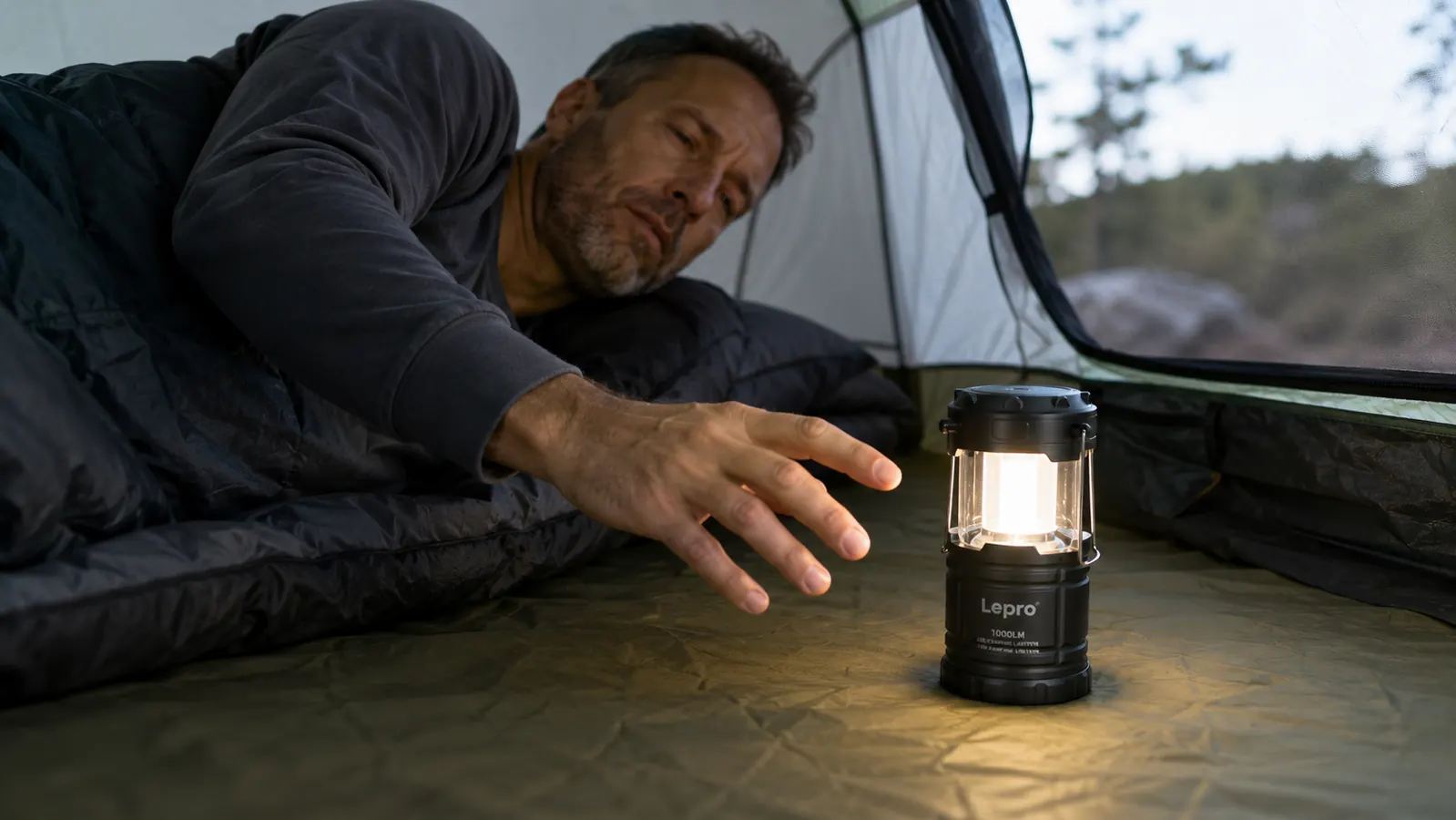 Lepro lantern hanging from a tent ridgeline hook inside a family tent, illuminating sleeping bags and gear